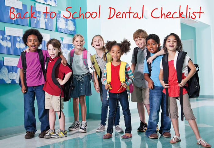 Smiling children making their back to school dental checklists.