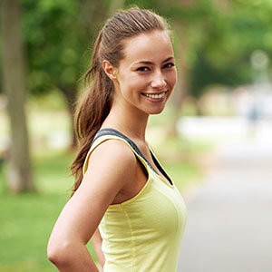 woman smiling for the camera before taking a run