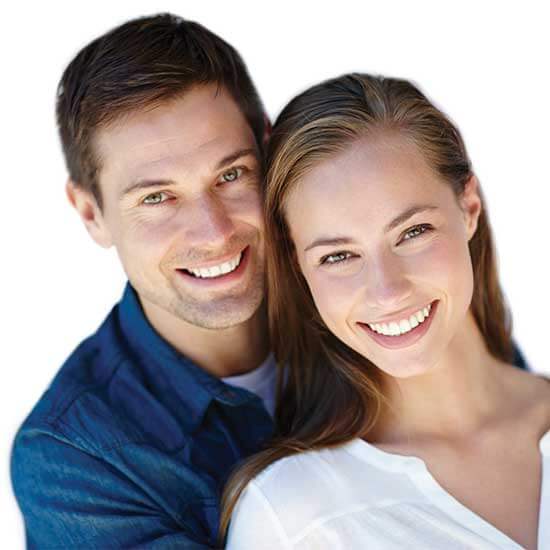 Couple smiling together after getting their porcelain veneers