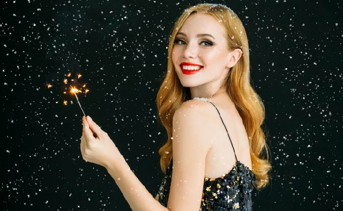 smiling woman with sparkler