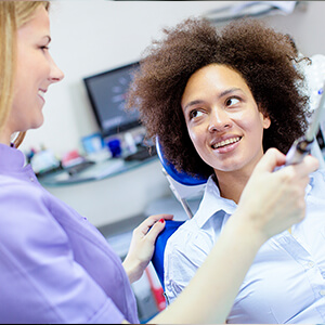 dental hygienist speaking with a patient