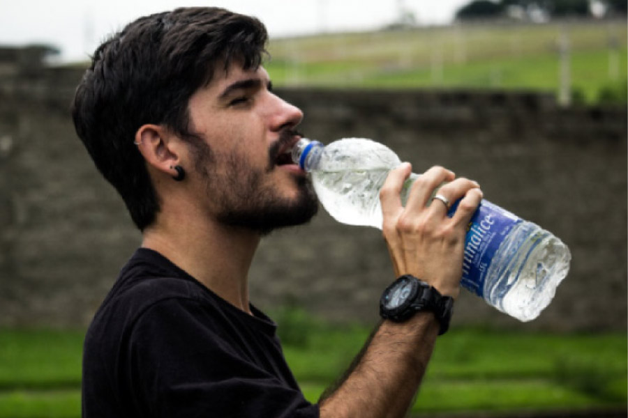 man drinking a bottle of water