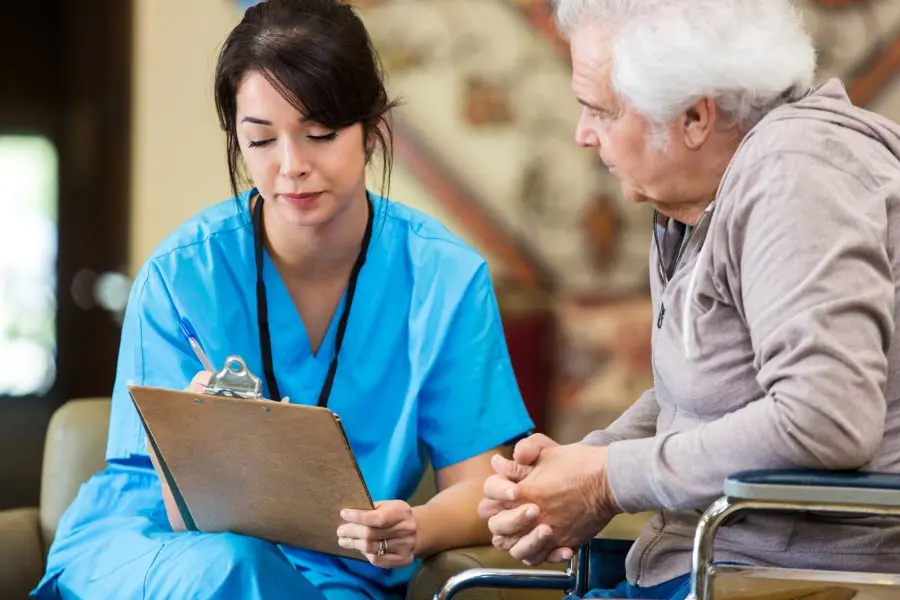 senior man discusses gum disease with a female dentist